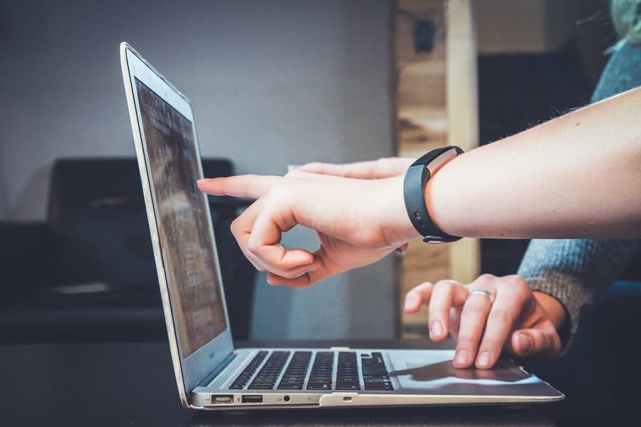 Two people using a laptop.