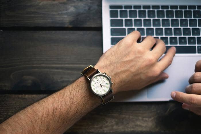 professional writer man's arm with a watch