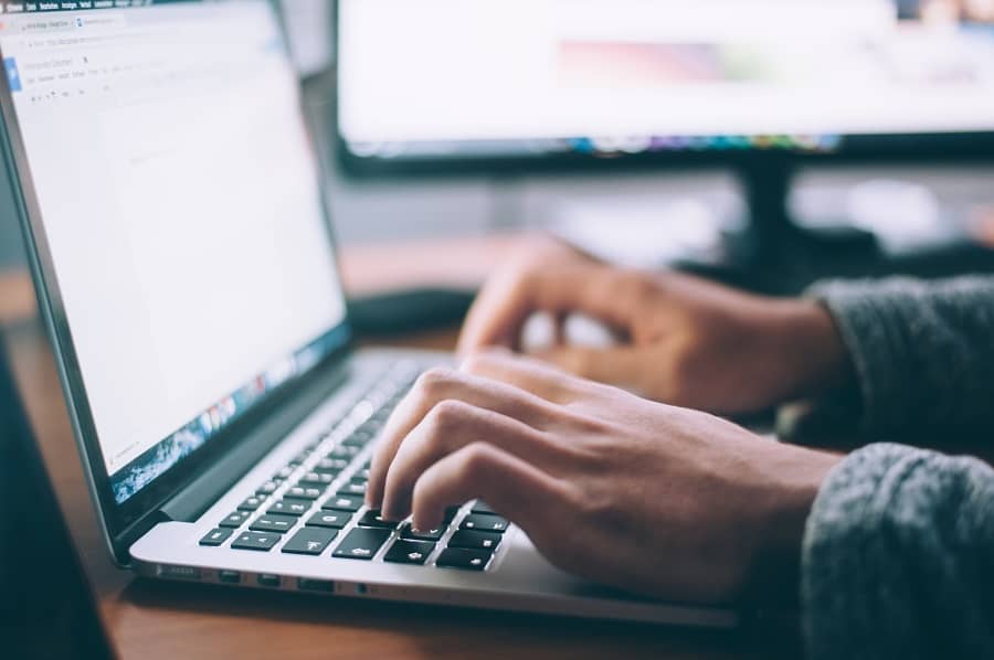 SEO writing a woman typing on a laptop.