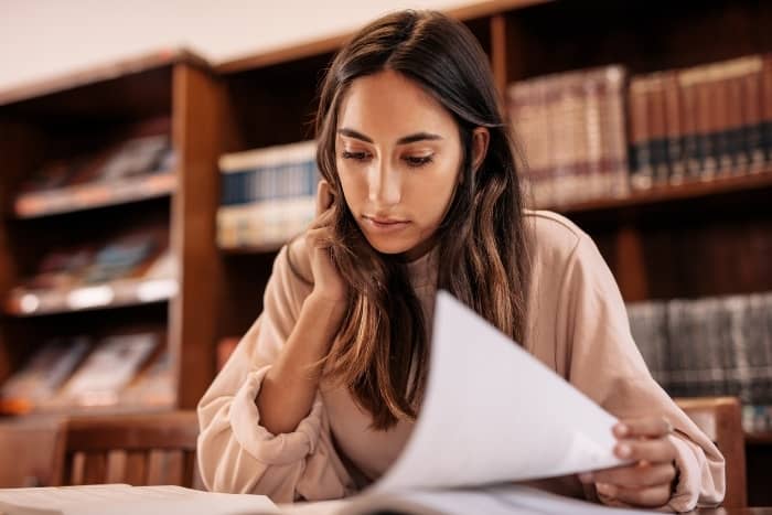 writing process woman researching in library