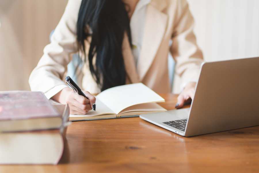 women taking notes on writing styles